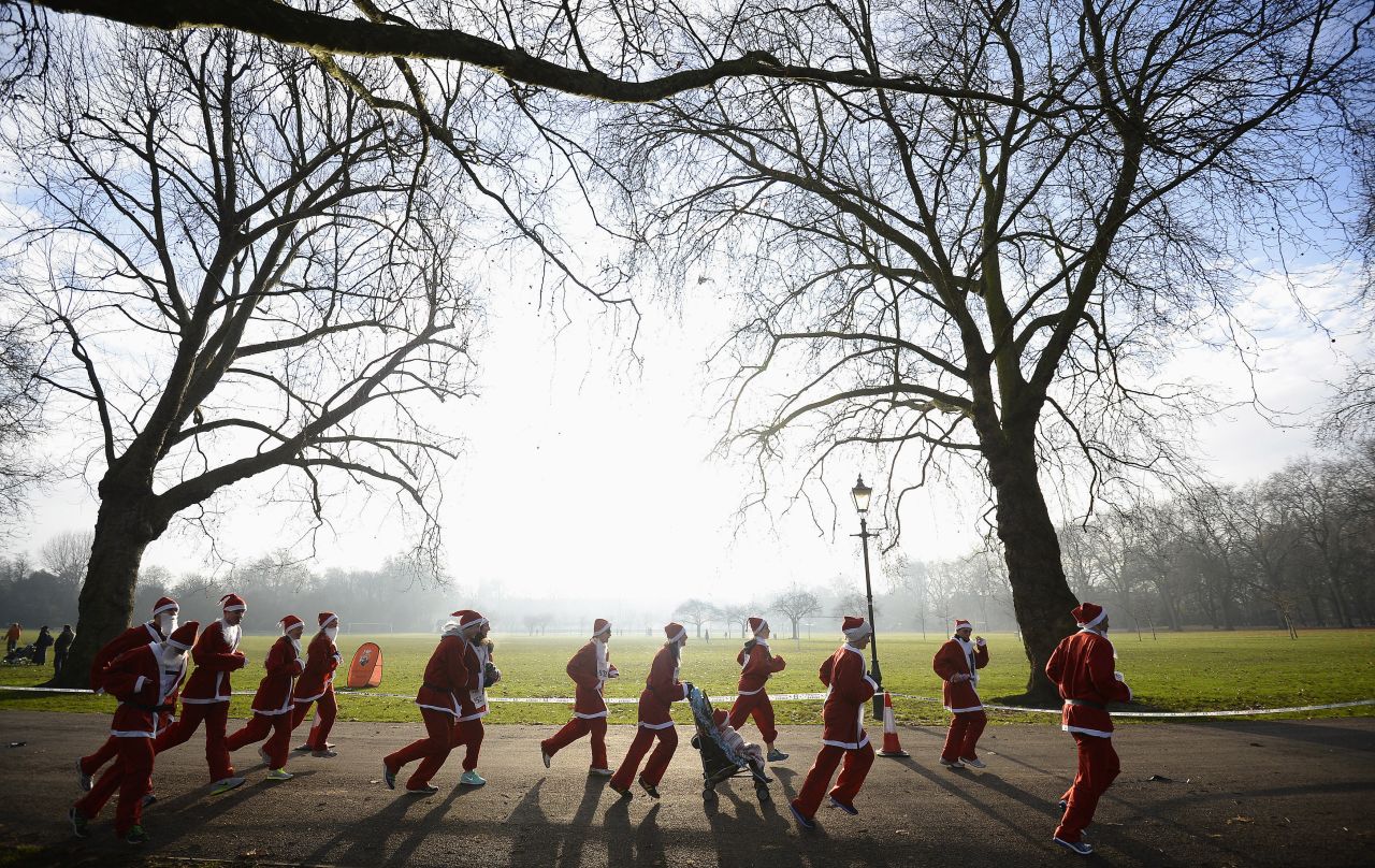 Competitors run in the annual 6-kilometer Santa Run in Battersea Park, London, on December 1.