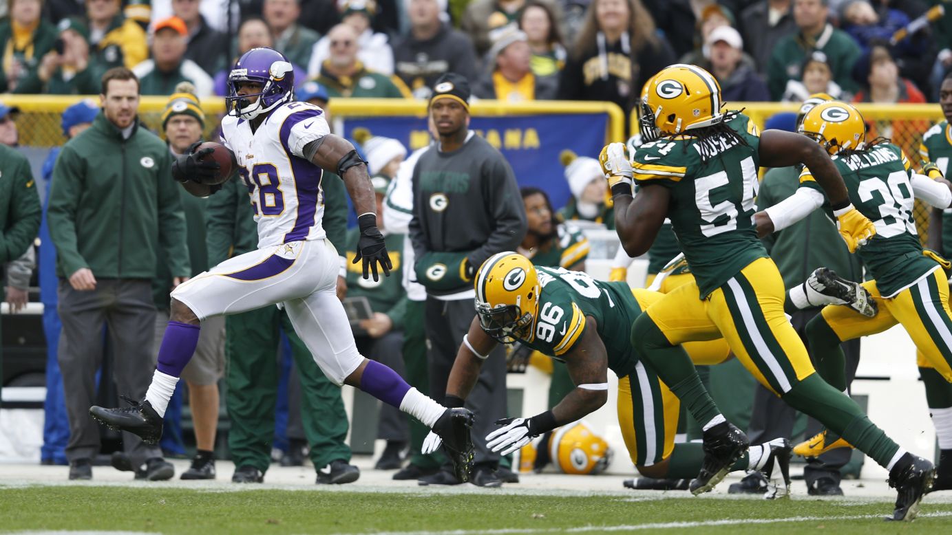 Adrian Peterson of the Minnesota Vikings breaks free for an 82-yard touchdown run against the Green Bay Packers at Lambeau Field on Sunday in Green Bay, Wisconsin. 