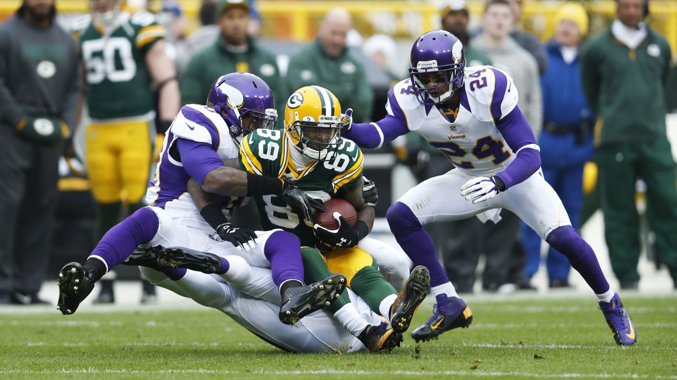 James Jones of the Green Bay Packers gets tackled on Sunday by Erin Henderson, left, and A.J. Jefferson of the Minnesota Vikings.