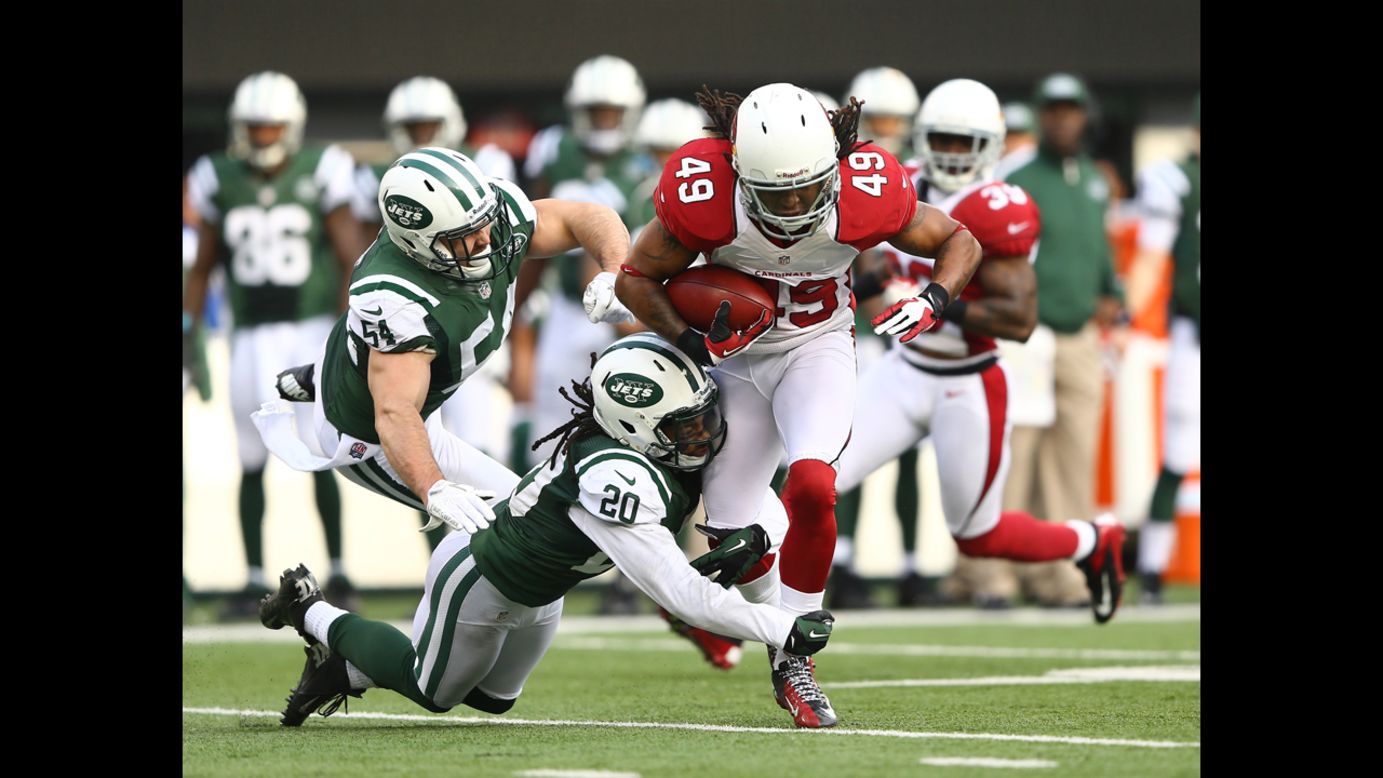 Rashad Johnson of the Arizona Cardinals gets a first down on a fake punt as Kyle Wilson of the New York Jets makes the tackle on December 2 at MetLife Stadium in East Rutherford, New Jersey.