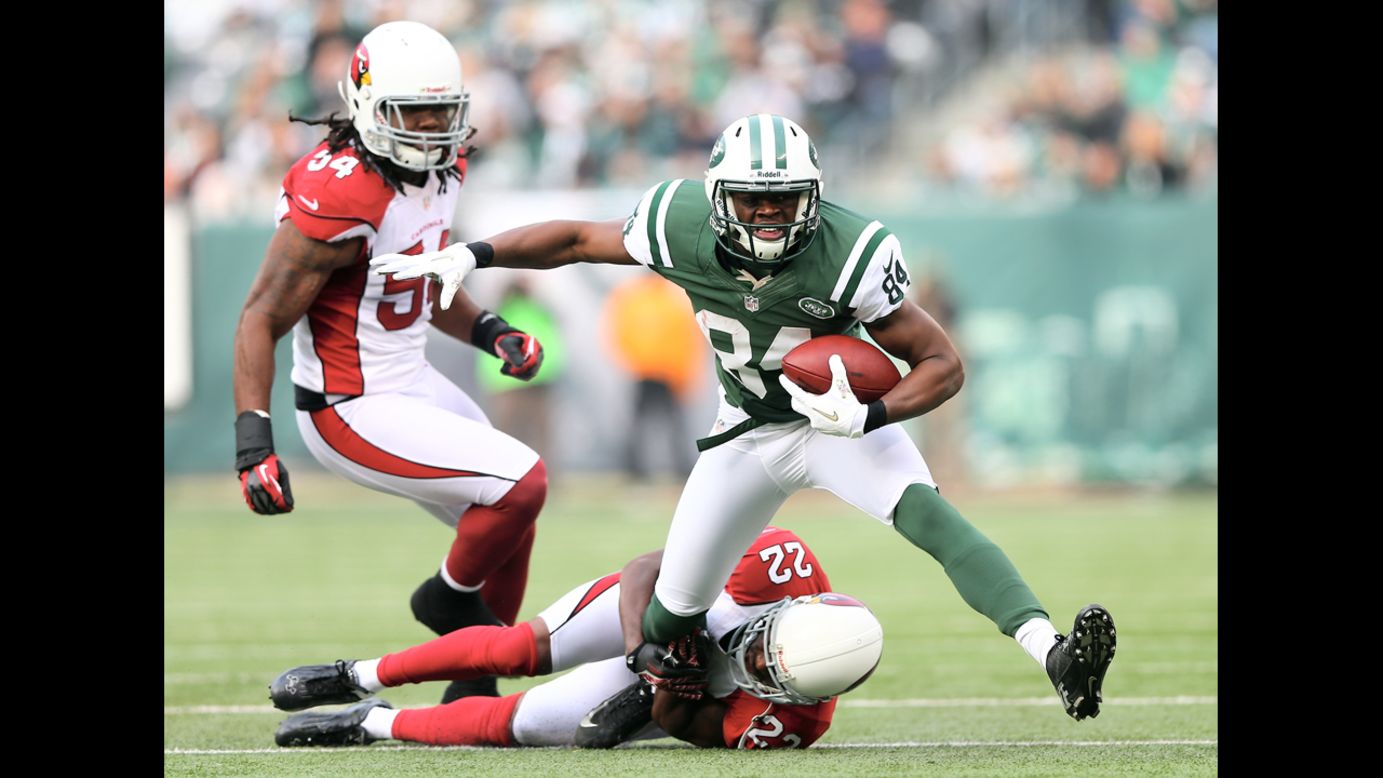 Stephen Hill of the New York Jets tries to get a few extra yards as Quentin Groves, left, and William Gay, bottom, of the Arizona Cardinals defend on Sunday.