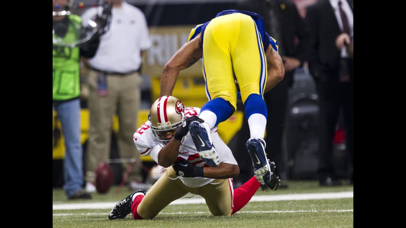 Cornerback Carlos Rogers of the San Francisco 49ers tackles tight end Lance Kendricks of the St. Louis Rams on Sunday.