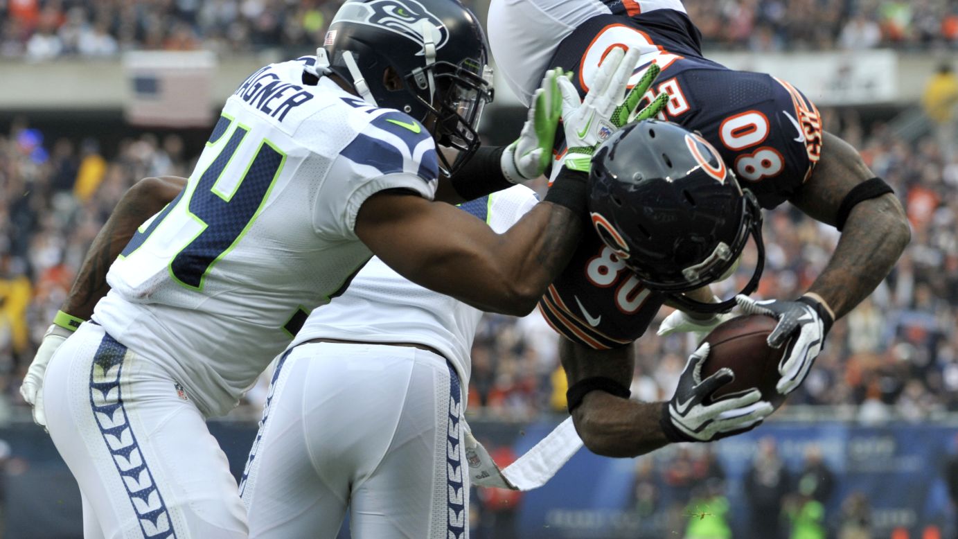 Earl Bennett of the Chicago Bears catches a touchdown pass as he's tackled by Bobby Wagner of the Seattle Seahawks on Sunday at Soldier Field in Chicago.