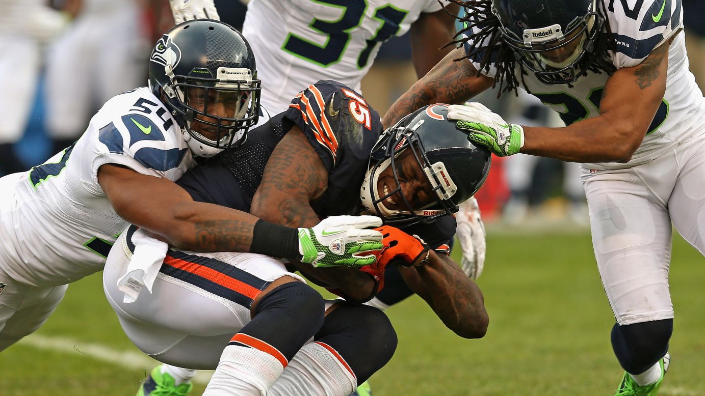 Brandon Marshall of the Chicago Bears is tackled after a catch by Bobby Wagner, left, and Earl Thomas of the Seattle Seahawks on Sunday.