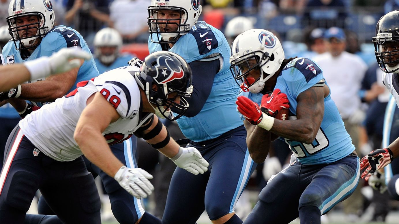 J.J. Watt of the Houston Texans tackles Chris Johnson of the Tennessee Titans on Sunday at LP Field in Nashville, Tennessee.
