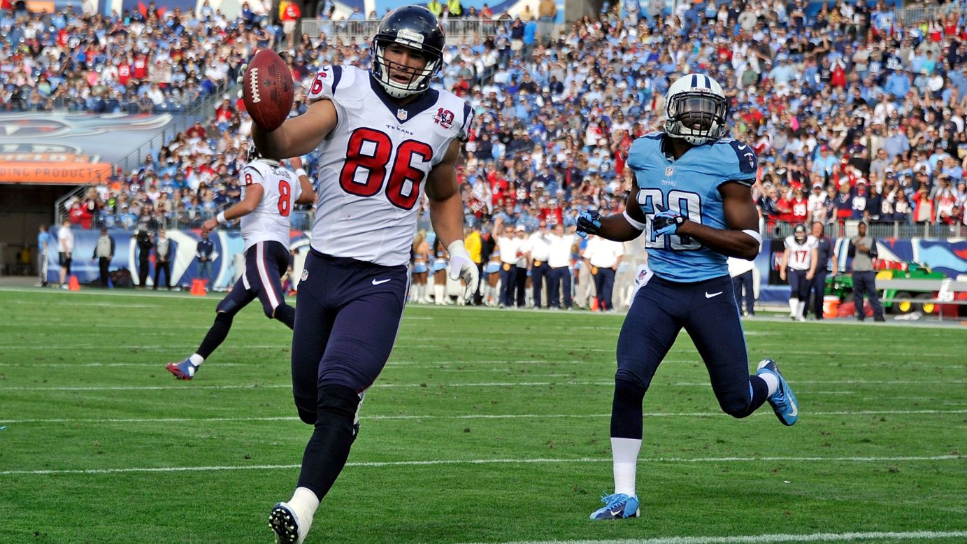 Ryan Mouton of the Tennessee Titans pursues James Casey of the Houston Texans as he enters the end zone on Sunday.