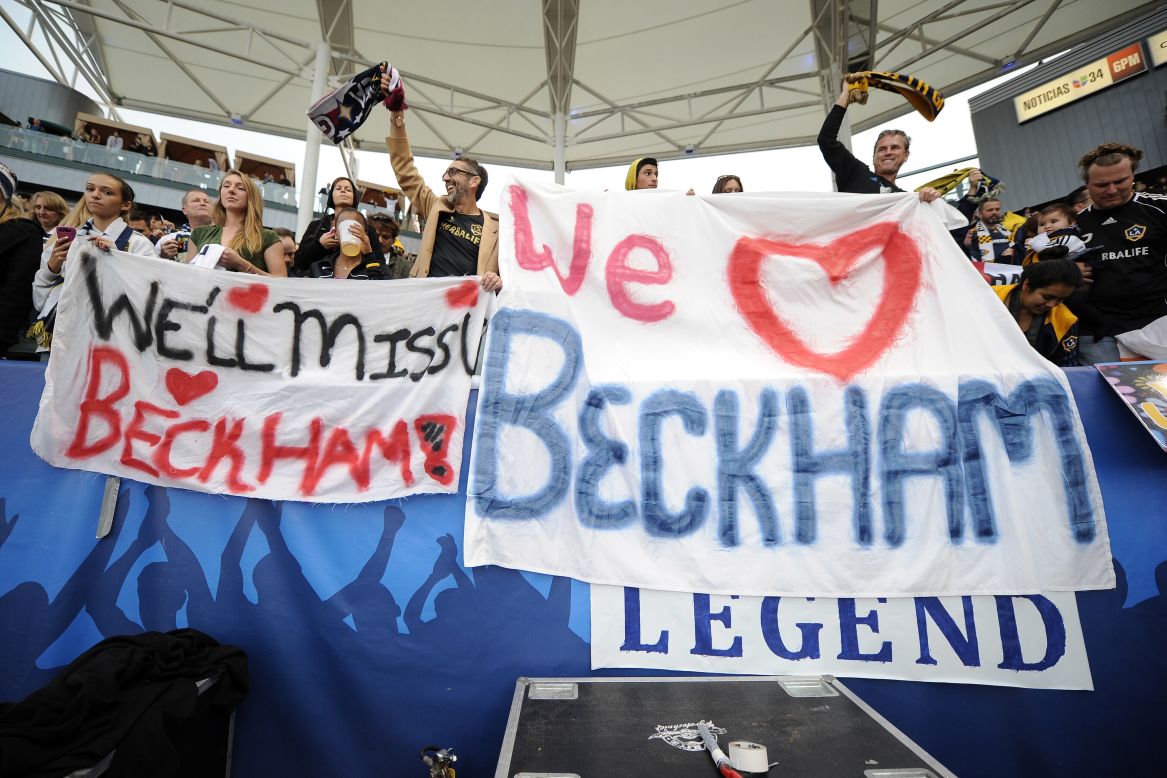 Fans hold up signs for Beckham  at The Home Depot Center during the game.