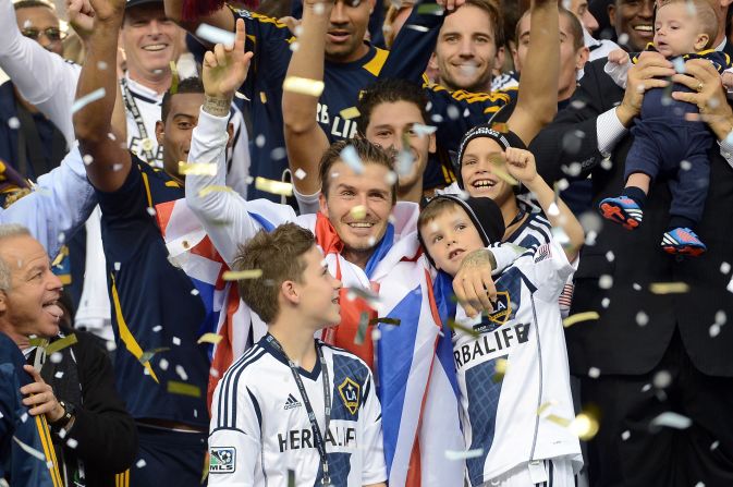 After the win, Beckham celebrates with his sons Brooklyn, Romeo and Cruz.