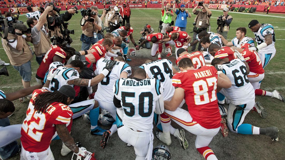 Players from the Kansas City Chiefs and Carolina Panthers gather at midfield for a prayer after the Chiefs' 27-21 win.