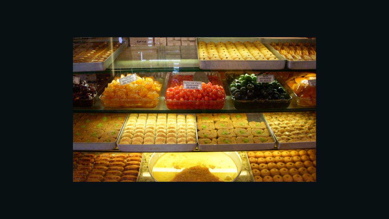 Rows of candied fruit and baklava line a display case at a Turkish confectionary in Istanbul.