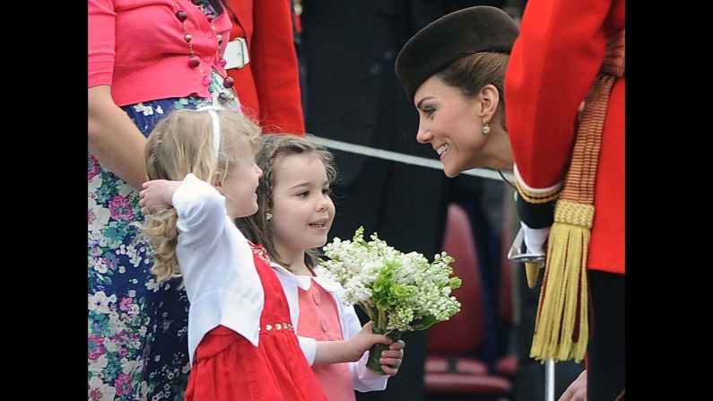 Catherine speaks with two young girls as she presents shamrocks to members of the 1st Battalion Irish Guards at the St Patrick's Day Parade on March 17, 2012, at Mons Barracks in Aldershot. 