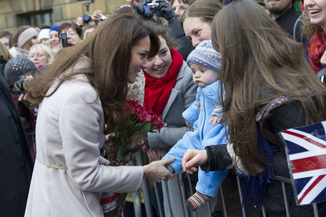 Catherine, Duchess of Cambridge, left, meets 5-month-old James William Davies as she arrives at the Guildhall during her visit to Cambridge on November 28, 2012. Prince William and his wife, Catherine, are expecting their first child, the palace announced Monday, December 3. Click through this gallery to see the her interacting with the younger generation.