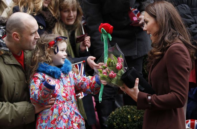 A young girl offers Catherine a toy rose as the Duchess visits Alder Hey Children's Hospital on February 14, 2012, in Liverpool, England. Interacting with children during visits to hospital or charities is a part of official duties that Catherine seems to enjoy.