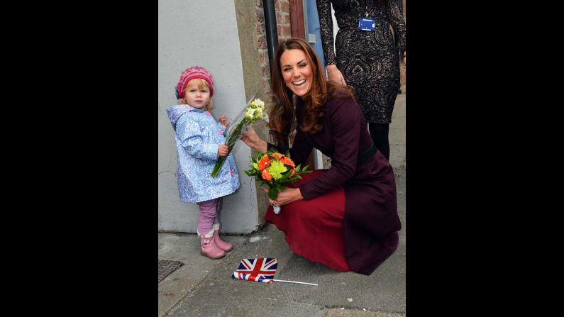 Catherine laughs as she receives flowers from 2-year-old Lola Mackay, who refused to let go of them, during a visit to the CRI Stockton Recovery Service on October 10, 2012, in Stockton-on-Tees, England.  