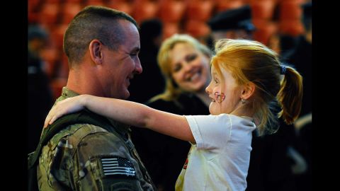 <strong>March 28: </strong>Sgt. 1st Class Paul Brady of the 182nd Infantry Massachusetts National Guard embraces his 6-year-old daughter, Regan, during a welcome home ceremony in Melrose, Massachusetts. The 182nd Infantry Regiment, one of the original units in the United States military, returned from a yearlong deployment in Afganistan.