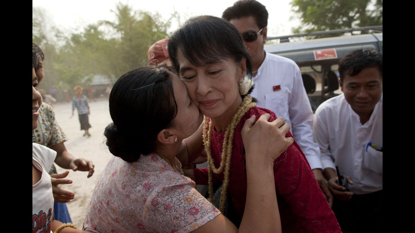 <strong>April 1: </strong>A supporter kisses Aung San Suu Kyi, leader of the National League for Democracy, as she visits polling stations in her constituency as Burmese vote in parliamentary elections in Kawhmu, Myanmar. She won a seat in parliament in Myanmar's first multiparty elections since 1990.