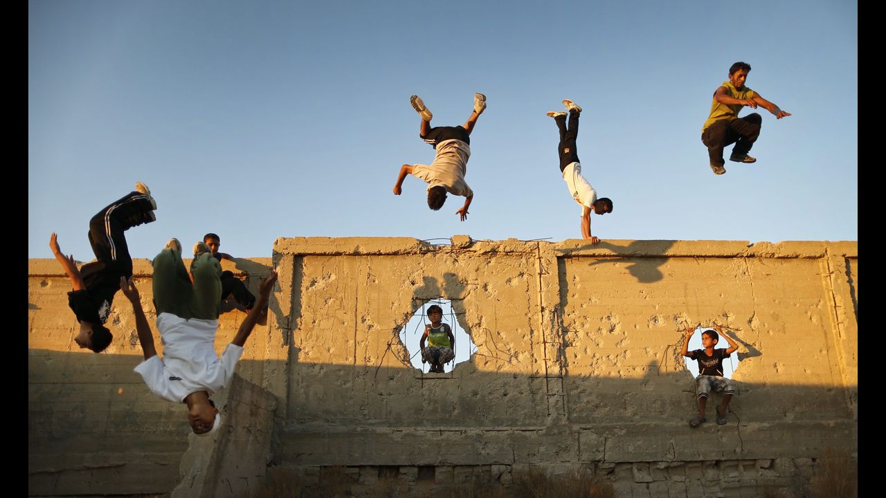 <strong>September 17: </strong>Palestinian youths practice their parkour skills in Khan Younis in southern Gaza. Parkour athletes run along a route, using obstacles to propel themselves. The practice originiated in France.