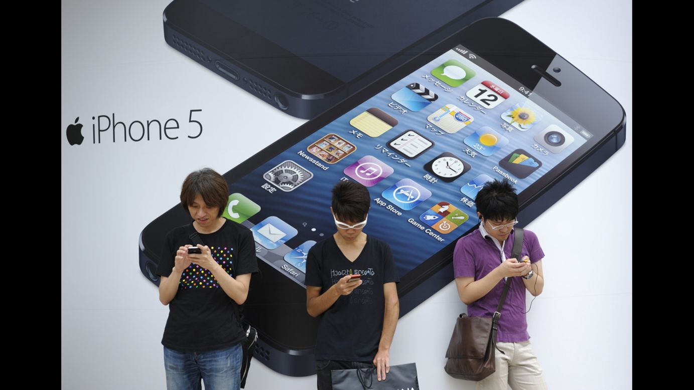 <strong>September 21:</strong> People stand outside a store in Tokyo before the launch of the iPhone 5. Based on first-day orders, the iPhone 5 became the fastest-selling device Apple has released.