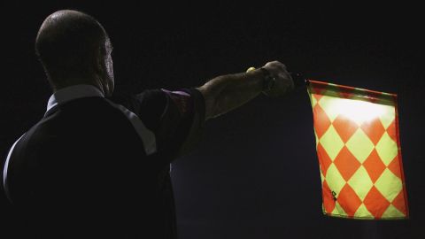  A file photo of a linesman raising his flag during a soccer match.