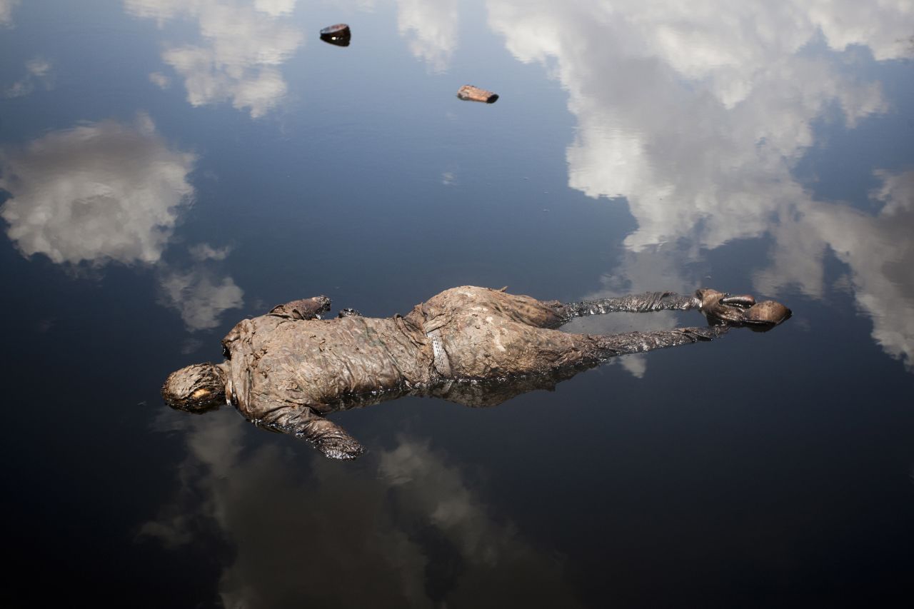<strong>April 17: </strong>A Sudan Armed Forces soldier lies dead in a pool of oil next to a leaking oil facility. He had engaged in heavy fighting with Sudan People's Liberation Army troops from South Sudan.