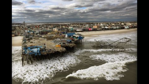 <strong>October 31:</strong> Waves break in front of a destroyed amusement park wrecked by Superstorm Sandy in Seaside Heights, New Jersey.