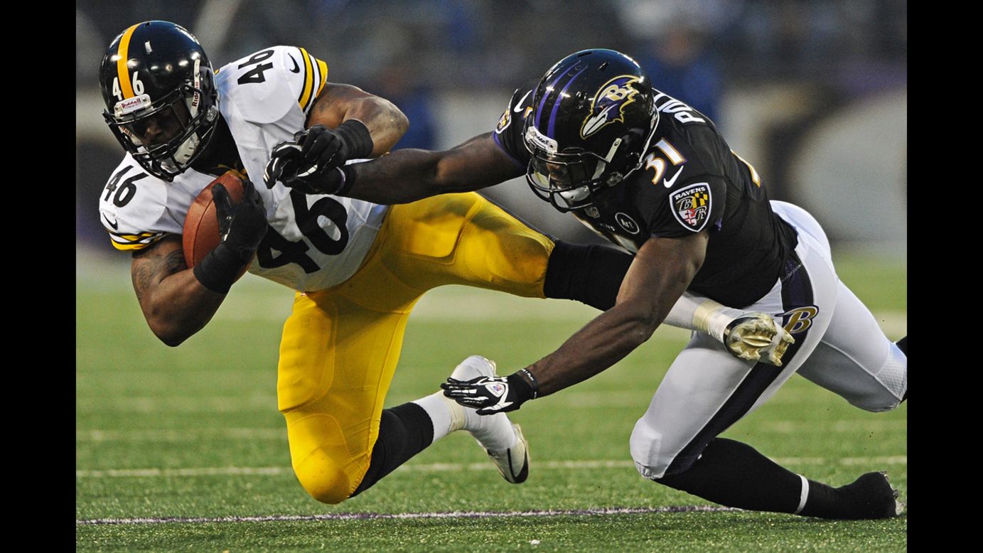 Fullback Will Johnson of the Pittsburgh Steelers is tackled by safety Bernard Pollard of the Baltimore Ravens on Sunday.