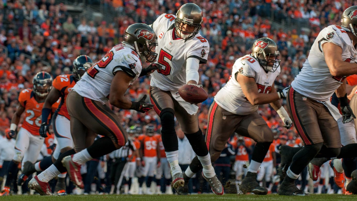 Quarterback Josh Freeman of the Tampa Bay Buccaneers hands the ball off to running back Doug Martin in their game against the Denver Broncos on Sunday.