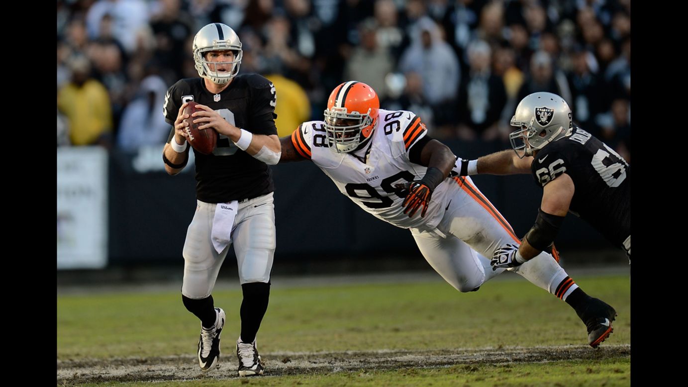 Carson Palmer of the Oakland Raiders scrambles away from the pressure of Phil Taylor of the Cleveland Browns on Sunday.