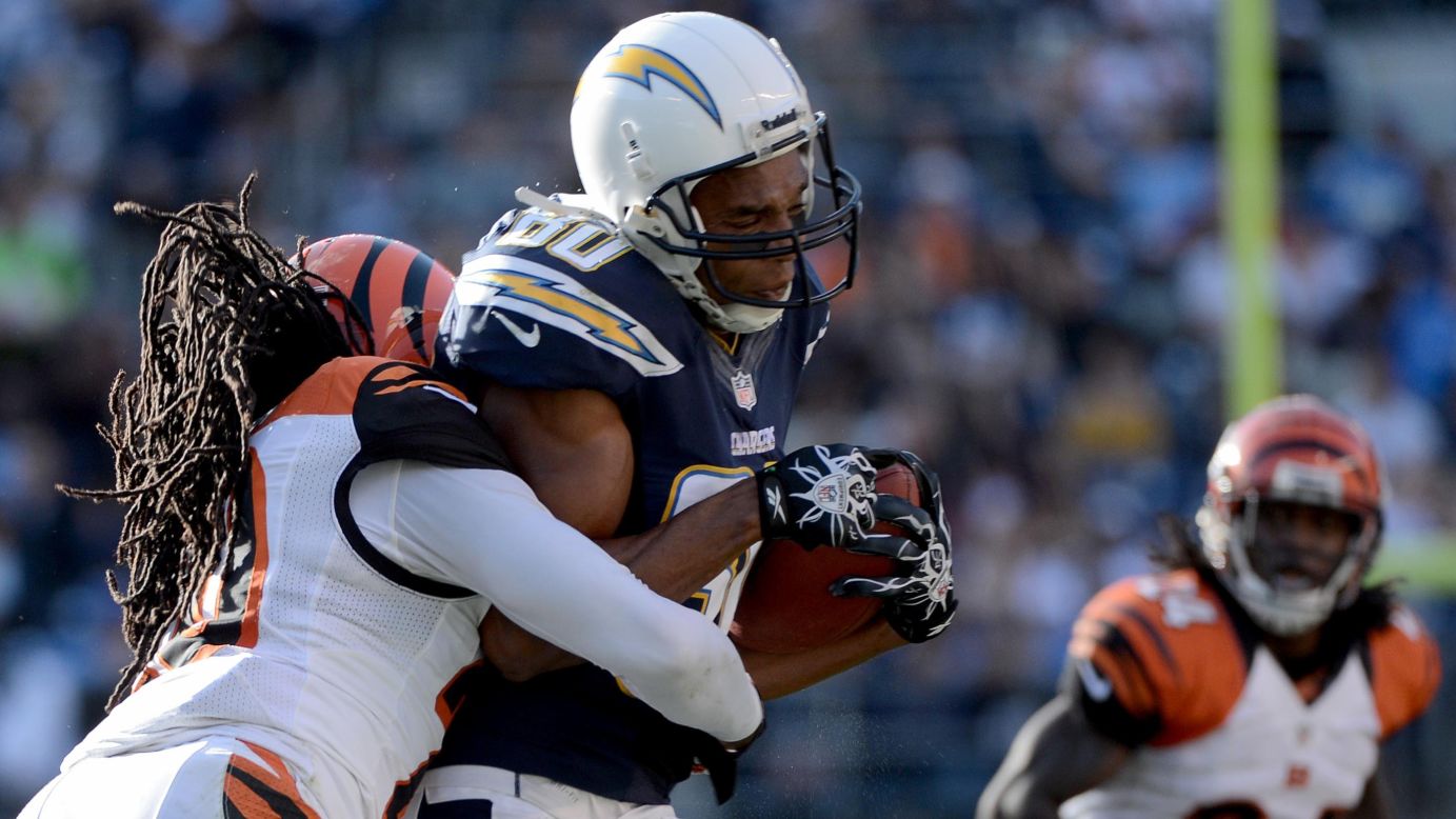 Malcom Floyd of the San Diego Chargers gets tackled by Reggie Nelson of the Cincinnati Bengals on Sunday.