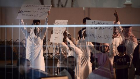 Bahrainis hold up banners Saturday during a protest against Kim Kardashian, who was promoting Millions of Milkshakes.
