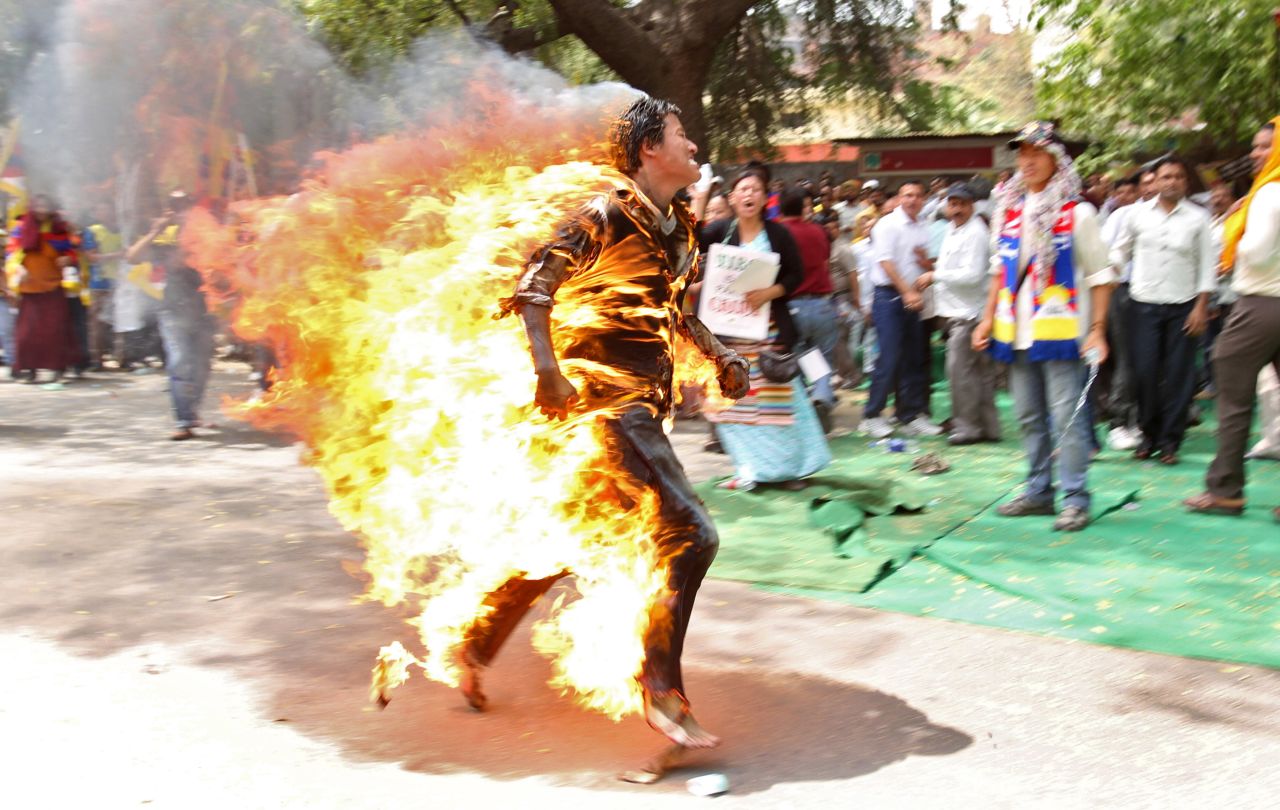 <strong>March 26: </strong>A Tibetan exile runs after setting himself on fire in New Delhi, India, during a protest against Chinese President Hu Jintao's upcoming visit.