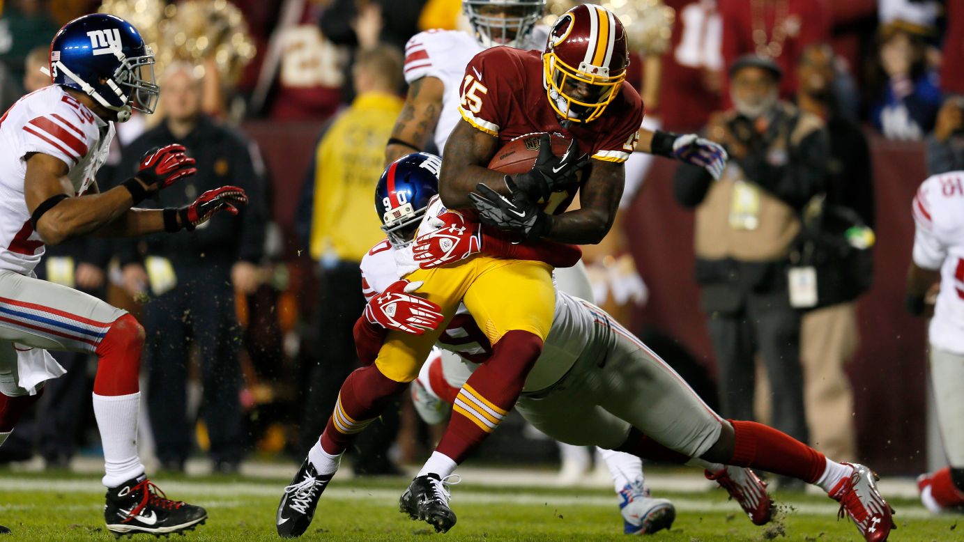 Josh Morgan of the Washington Redskins runs the ball as he is hit by Jason Pierre-Paul of the New York Giants before scoring a touchdown after recovering a fumble on Monday, December 3, at FedExField in Landover, Maryland. Check out the action from Week 13 of the NFL, and <a href="http://www.cnn.com/2012/11/22/football/gallery/nfl-week-12/index.html">look back at the best photos from Week 12</a>.