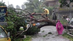 Workers clear a road with a fallen tree after Typhoon Bophal hit the city of Tagum, Davao del Norter province, on the southern island of Mindanao on December 4, 2012. Typhoon Bopha smashed into the southern Philippines early December 4, as more than 40,000 people crammed into shelters to escape the onslaught of the strongest cyclone to hit the country this year. AFP PHOTO (Photo credit should read AFP/AFP/Getty Images) 