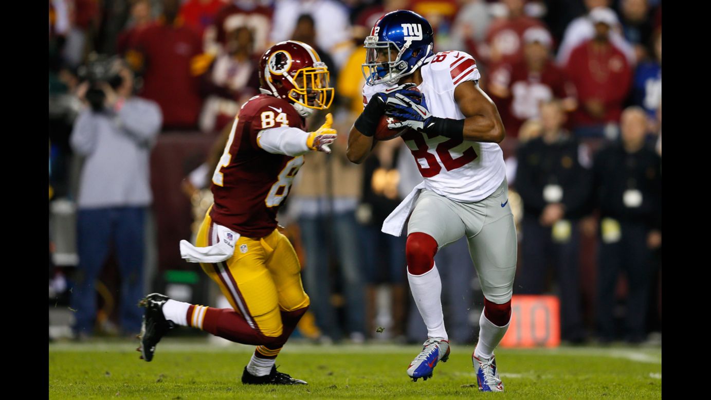 Kick returner Rueben Randle of the New York Giants runs by Niles Paul of the Washington Redskins to start the game on Monday.