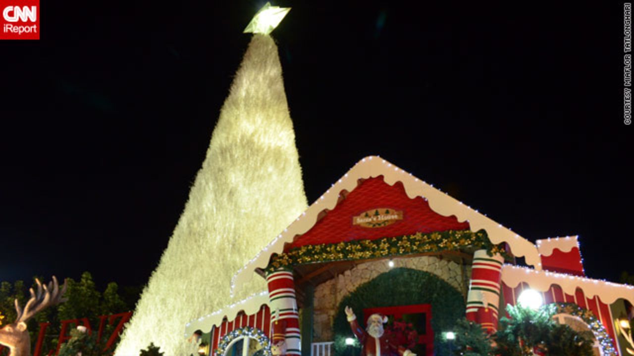 In the Philippines, Christmas trees come <a href="http://ireport.cnn.com/docs/DOC-887845">in all shapes and sizes</a> -- this one in iReporter Miaflor Tatlonghari's image is at least 30ft tall and towers over Santa Claus's house in Santa Rosa city.