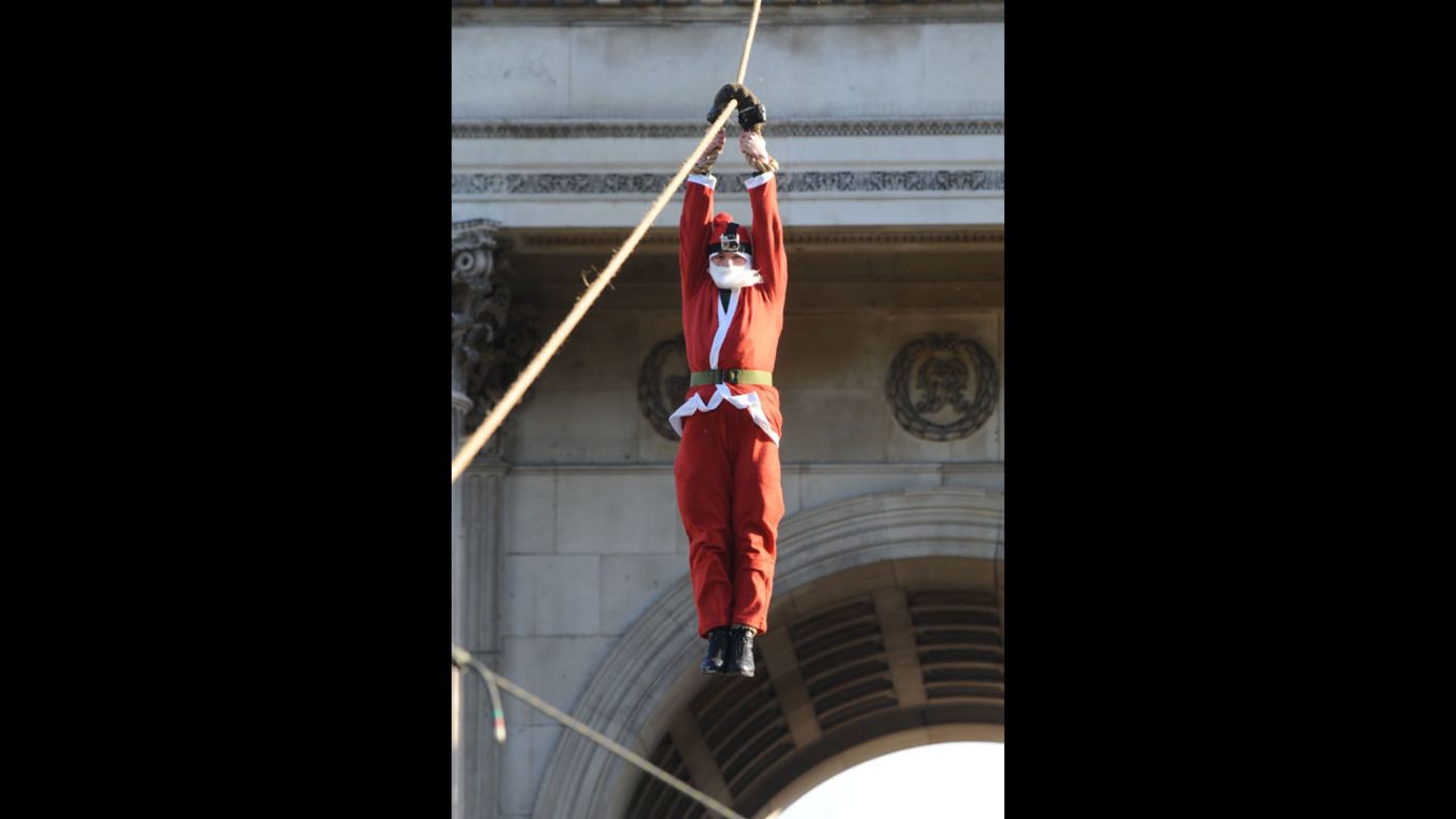 Santa descends on a rope during Christmas Box Launch at Wellington Arch in London's Hyde Park on Tuesday, December 4.