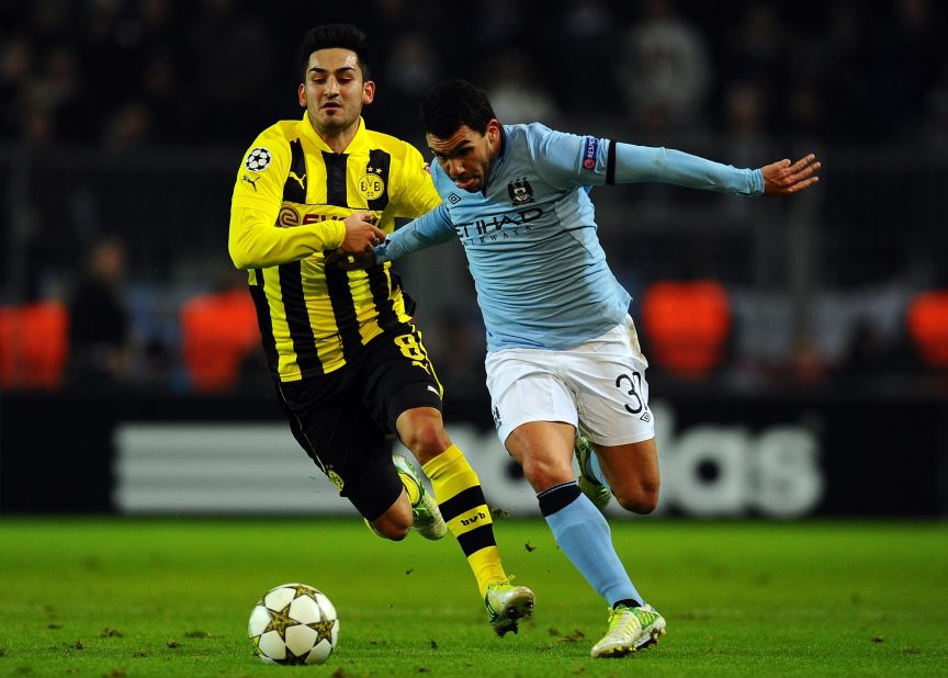 Carlos Tevez takes on Ilkay Guendogan of Borussia Dortmund during a frustrating night for Manchester City as it crashed out of European competition with a 1-0 defeat. City becomes the first English team to have failed to win a single group game in the compeititon.