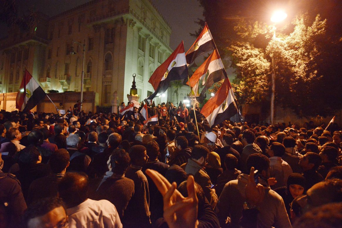 Tens of thousands of demonstrators encircled the presidential palace in Cairo after riot police failed to keep them at bay with tear gas on December 4.