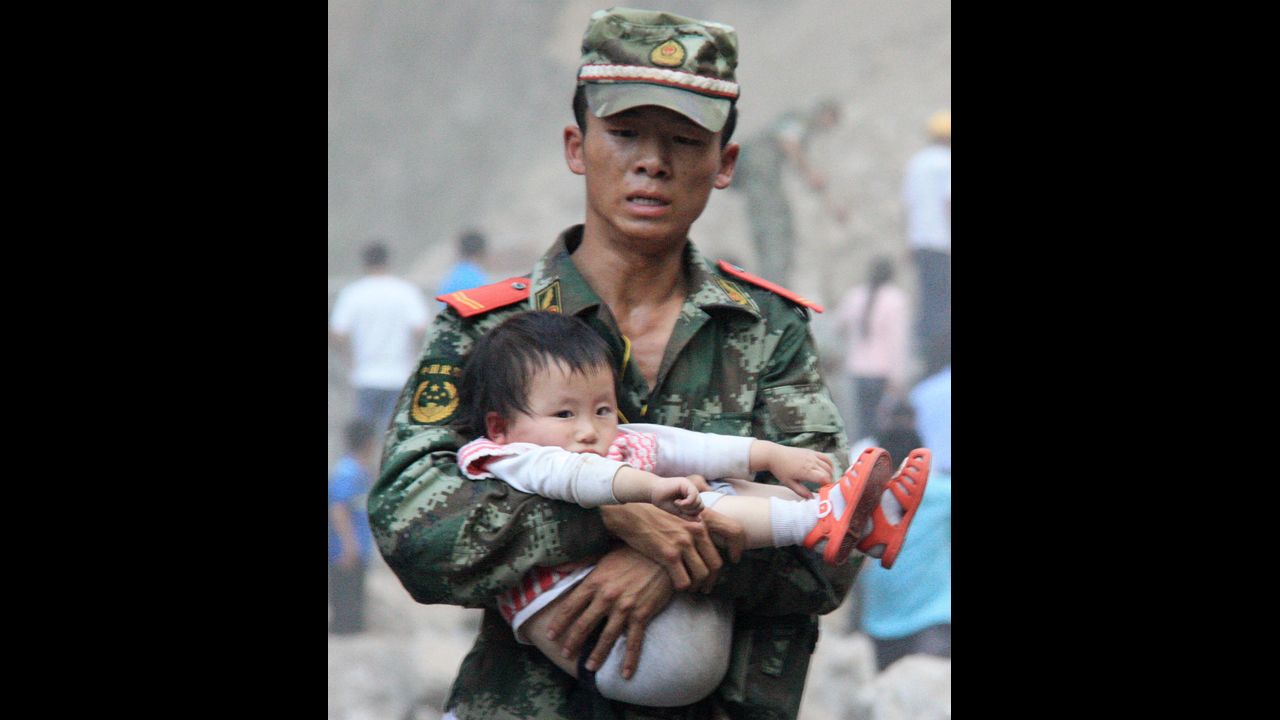 <strong>September 9: </strong>A rescue worker carries a child in Yiliang County, China. At least 80 people were killed and more than 800 others were injured after two earthquakes jolted southwest China.