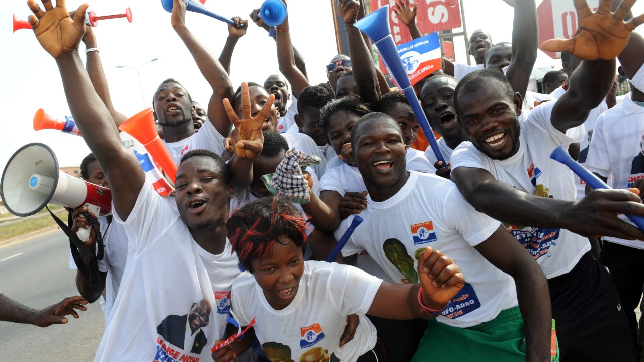 Supporters of Ghana's New Patriotic Party, hold vuvuzelas as they dance in the streets of Kasoa, Ghana, on December 1, 2012.