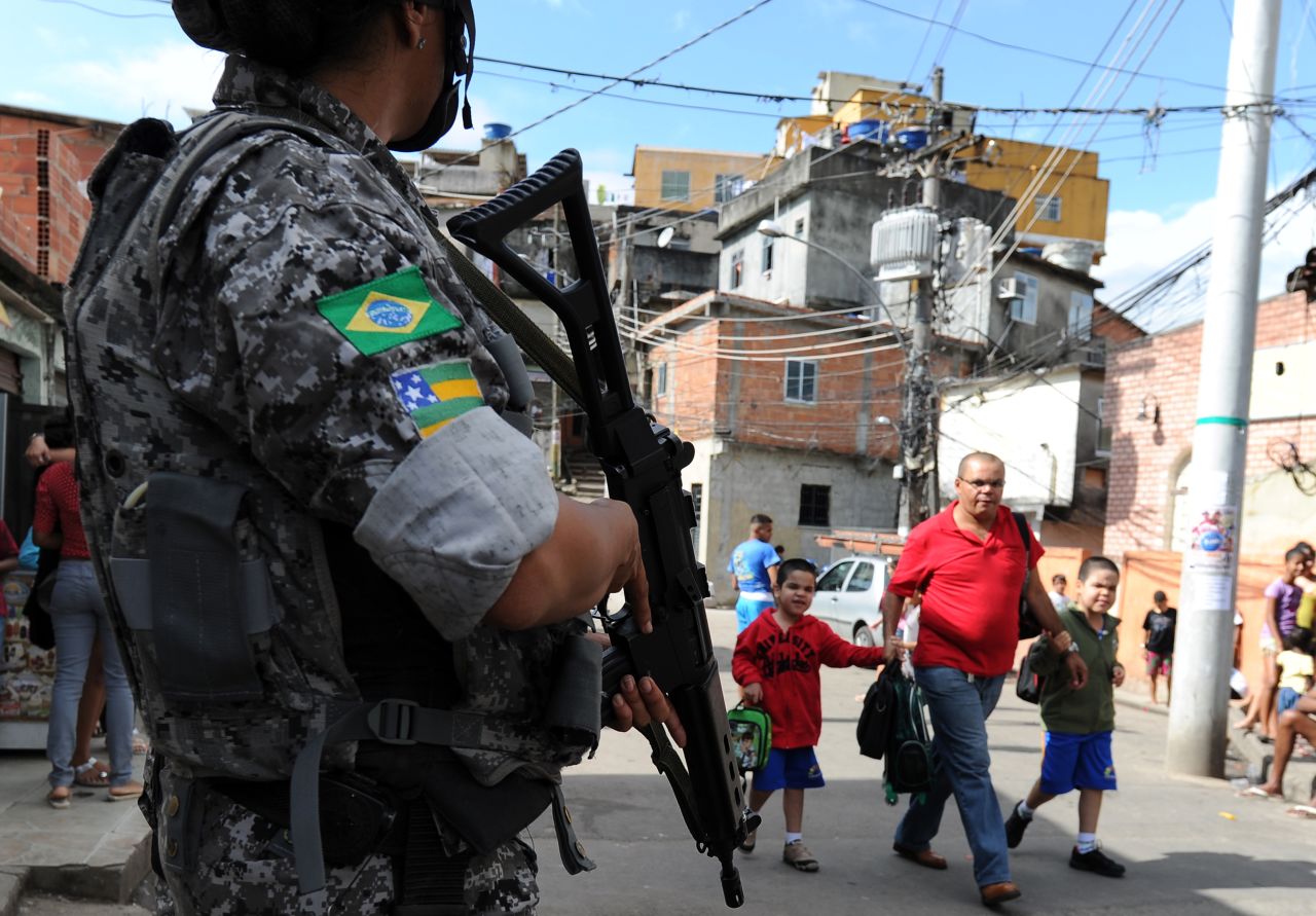 The Brazilian government has implemented programs to control violence in shantytowns around the country. Here an officer patrols one of Rio de Janeiro's favelas.