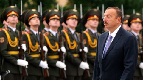 Azerbaijani President Ilham Aliyev pardoned a convicted ax murderer after he was extradited from Hungary.