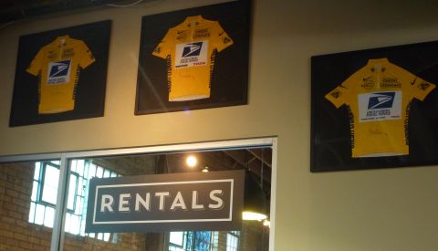 Three of Armstrong's yellow jersey hang inside Mellow Johnny's.