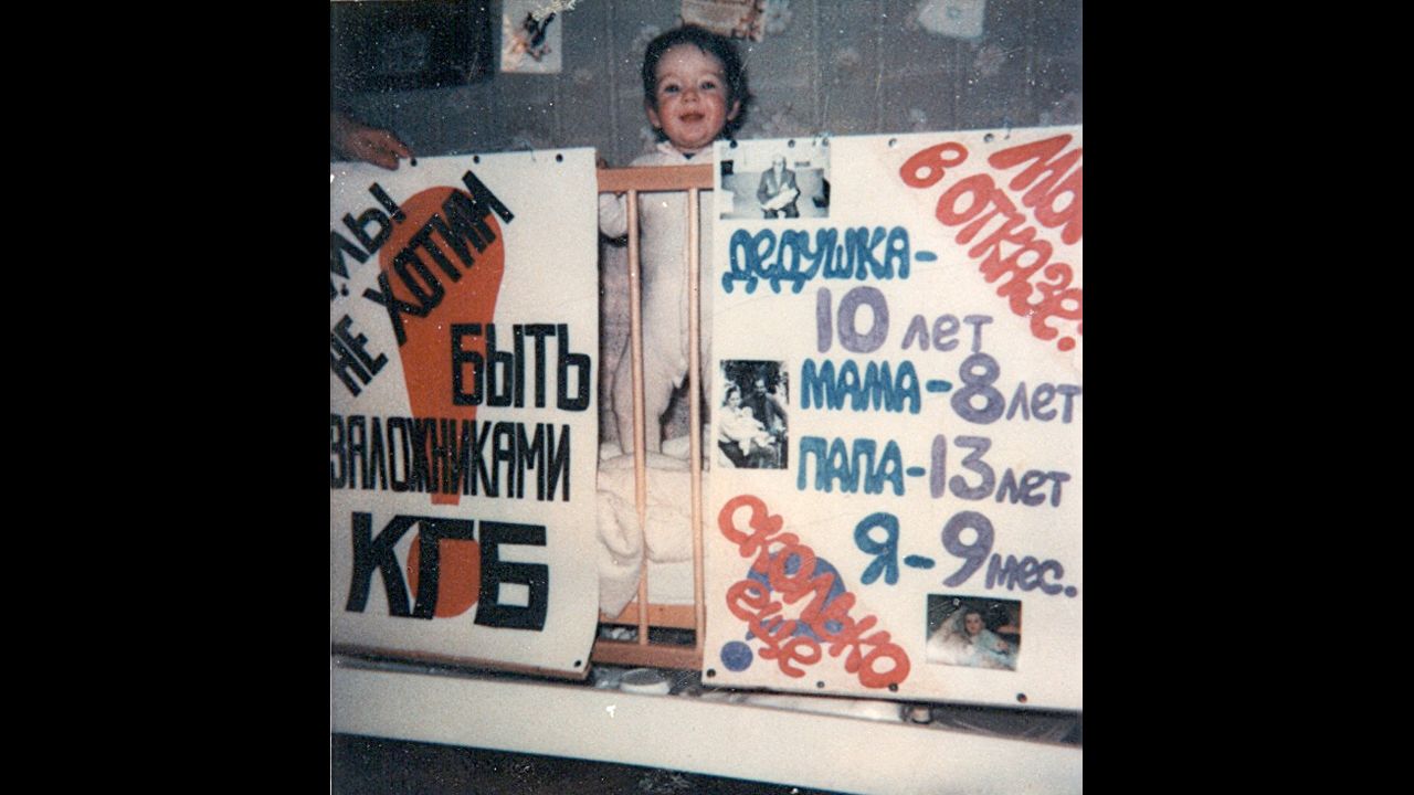 The night before the Furmans took a final stand, their 9-month-old daughter Aliyah posed with posters, made by family friends. The one on the left reads in Russian, "We don't want to be hostages of KGB!" 