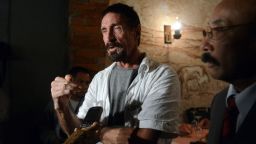 US anti-virus software pioneer John McAfee (L) answers questions to a journalist next to his Guatemalan lawyer Telesforo Guerra (R), in a restaurant in Guatemala City on December 04, 2012. McAfee, wanted for questioning over the murder of his neighbor last month in Belize, is seeking political asylum in Guatemala. 