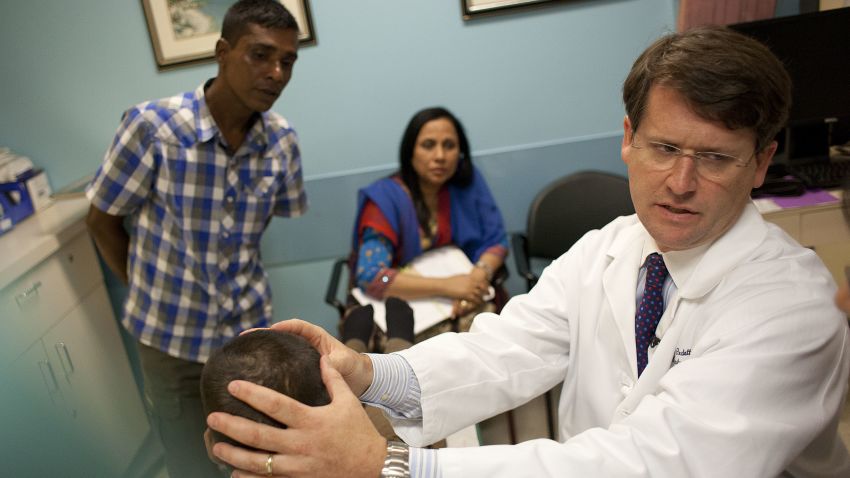 Dr. Redett examines the young boy's head.