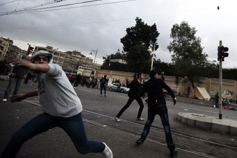 Supporters of Morsy clash with anti-Morsy protesters outside the Egyptian presidential palace on Wednesday, December 5, in Cairo.