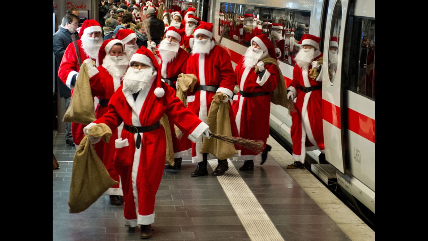 Around 400 people dressed as Santa Claus arrive by train in Frankfurt am Main, Germany, on December 6.