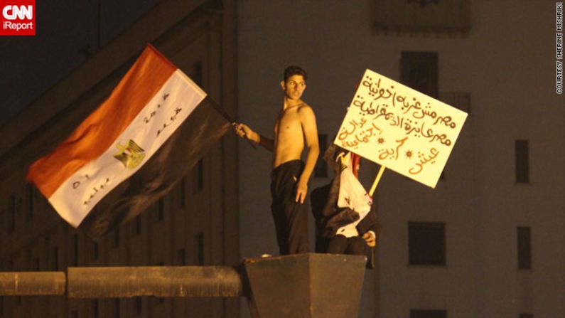 At earlier protests, those gathered were "hopeful and very determined," said iReporter Sherine Mishriki, who sent in this image of youths <a href="http://ireport.cnn.com/docs/DOC-887373">waving flags and placards</a> in Cairo's iconic Tahrir Square on November 27.