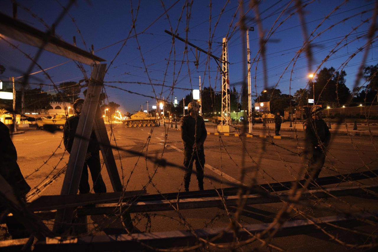 Egyptian soldiers stand outside the presidential palace in Cairo after setting up barbed wire barricades on December 6.